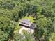 Expansive aerial view of a home surrounded by lush greenery and a charming fenced yard at 820 King Rd, Clover, SC 29710
