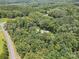 Wide aerial view of a secluded home nestled in a dense forest, showcasing its privacy at 820 King Rd, Clover, SC 29710