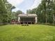 Expansive backyard with a large screened patio and lush green grass, perfect for outdoor activities at 820 King Rd, Clover, SC 29710