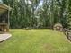 Large backyard with a storage shed and ample space for recreation, bordered by mature trees at 820 King Rd, Clover, SC 29710