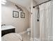 Cozy bathroom with a walk-in shower, modern sink, and decorative wall art at 820 King Rd, Clover, SC 29710