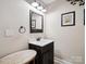 Bathroom featuring a modern sink vanity, neutral colors, and a decorative mirror at 820 King Rd, Clover, SC 29710