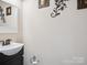 Half-bath showcasing a pedestal sink, stylish fixtures, and neutral decor at 820 King Rd, Clover, SC 29710