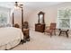 Bright bedroom with a four-poster bed, vintage decor, and soft carpet at 820 King Rd, Clover, SC 29710