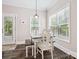Bright breakfast nook with natural light, rustic table, and bench seating, perfect for casual dining at 820 King Rd, Clover, SC 29710