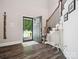 Open foyer with wood floors, staircase, and an inviting front door view at 820 King Rd, Clover, SC 29710
