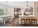Well-lit kitchen features granite countertops, a pantry, stainless steel appliances, and seating at the breakfast bar at 820 King Rd, Clover, SC 29710