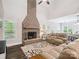 Comfortable living room with a striking brick fireplace and plush seating at 820 King Rd, Clover, SC 29710
