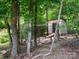 Chicken coop nestled in wooded yard provides farm-fresh eggs and a rustic touch to the property at 820 King Rd, Clover, SC 29710