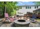 Backyard with firepit, lawn chairs, and spacious wood deck and lush trees at 8214 Aspen Ct, Mint Hill, NC 28227