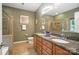 Bathroom with double sink vanity, granite countertops, and tiled shower at 8214 Aspen Ct, Mint Hill, NC 28227