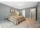 Cozy bedroom featuring neutral colors, a patterned bedspread, and ensuite bathroom access at 8214 Aspen Ct, Mint Hill, NC 28227