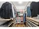 Organized walk-in closet featuring built-in shelving and hanging rods for ample storage at 8214 Aspen Ct, Mint Hill, NC 28227