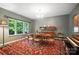 Bright dining room featuring a large window, stylish furnishings, a vintage rug, and a piano at 8214 Aspen Ct, Mint Hill, NC 28227
