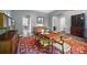 Stylish dining room with a colorful rug, elegant table setting, and a piano at 8214 Aspen Ct, Mint Hill, NC 28227