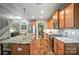 Kitchen features a large island, stone countertops, wood cabinets, stainless steel appliances, and hardwood floors at 8214 Aspen Ct, Mint Hill, NC 28227