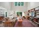 Bright living room features high ceilings, a sliding glass door to the deck, and built-in shelving for storage and display at 8214 Aspen Ct, Mint Hill, NC 28227