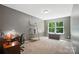 Spacious office with a ladder shelf and windows providing plenty of natural light at 8214 Aspen Ct, Mint Hill, NC 28227