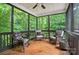 Screened porch with ceiling fan and a seating arrangement, perfect for enjoying the outdoors at 8214 Aspen Ct, Mint Hill, NC 28227