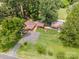 Aerial view of a sprawling home featuring multiple structures, a tennis court, and lush greenery at 835 Holshouser Rd, Rockwell, NC 28138