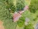 Aerial view of a home with tennis court surrounded by lush greenery and mature trees at 835 Holshouser Rd, Rockwell, NC 28138