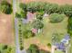 An aerial view shows a home with a private pool surrounded by well-maintained landscaping at 835 Holshouser Rd, Rockwell, NC 28138