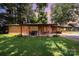 Charming backyard patio with inviting seating area and a lush lawn, blending comfort with nature at 835 Holshouser Rd, Rockwell, NC 28138