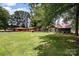 Large backyard showcasing a beautifully landscaped lawn with multiple structures at 835 Holshouser Rd, Rockwell, NC 28138