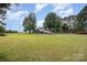 Sprawling lawn featuring a home and various outbuildings, offering space and country charm at 835 Holshouser Rd, Rockwell, NC 28138