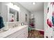 Neutral bathroom with plank flooring, large vanity, and shower with patterned curtain at 835 Holshouser Rd, Rockwell, NC 28138