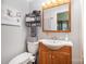 Well-lit bathroom featuring warm-toned vanity, wood floors, and storage shelving at 835 Holshouser Rd, Rockwell, NC 28138