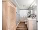 Bright bathroom with neutral walls, wood-look flooring, large linen closet, and a shower/tub with patterned curtain at 835 Holshouser Rd, Rockwell, NC 28138