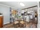 Cozy dining area with a glass table and wood floors, adjacent to the open kitchen at 835 Holshouser Rd, Rockwell, NC 28138