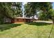 Single story house with brick facade and large grassy front yard, complete with mature trees at 835 Holshouser Rd, Rockwell, NC 28138