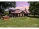 Picturesque home with a well-manicured lawn and inviting porch, blending charm with elegance at 835 Holshouser Rd, Rockwell, NC 28138