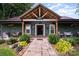 Inviting home exterior with a covered porch, wood columns, and landscaped walkway at 835 Holshouser Rd, Rockwell, NC 28138