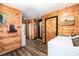 Wood-paneled laundry hallway with white washer/dryer and multiple doorways at 835 Holshouser Rd, Rockwell, NC 28138