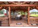 Inviting covered patio featuring a wooden frame, ample seating, and outdoor decor at 835 Holshouser Rd, Rockwell, NC 28138