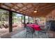 Covered patio featuring wood beamed ceiling, exterior decorations, a fire pit, and swing set at 835 Holshouser Rd, Rockwell, NC 28138