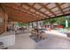 Expansive covered patio with views of the yard, decorated with multiple seating areas and dining sets at 835 Holshouser Rd, Rockwell, NC 28138