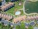 Aerial view of the community showing the swimming pool, pond, parking lot and surrounding buildings at 1018 Southwest Sw Dr # 18, Davidson, NC 28036