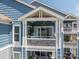 Charming balcony with white railing, offering a view of the surrounding lake and natural light at 1018 Southwest Sw Dr # 18, Davidson, NC 28036