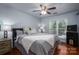 Serene bedroom with hardwood floors, cooling ceiling fan, and large window for natural light at 1018 Southwest Sw Dr # 18, Davidson, NC 28036