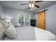 Comfortable bedroom with barn door, large window for natural light, and cooling ceiling fan at 1018 Southwest Sw Dr # 18, Davidson, NC 28036