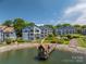Beautiful exterior view of blue condos with well-maintained landscaping and access to a dock at 1018 Southwest Sw Dr # 18, Davidson, NC 28036