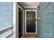 Welcoming front door of a unit with a welcome mat and stylish exterior lighting at 1018 Southwest Sw Dr # 18, Davidson, NC 28036