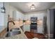 Modern kitchen featuring stainless steel appliances, granite counters and beautiful backsplash and wooden flooring at 1018 Southwest Sw Dr # 18, Davidson, NC 28036