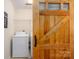 Laundry room with a washer and dryer, storage shelves and a sliding wood door at 1018 Southwest Sw Dr # 18, Davidson, NC 28036