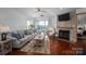 Bright living room featuring a stone fireplace, sliding door to outside patio, and comfortable seating area at 1018 Southwest Sw Dr # 18, Davidson, NC 28036