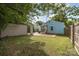 View of the home's backyard with a detached garage, patio, and a grassy area with a wooden fence at 1019 Richard St, Salisbury, NC 28144
